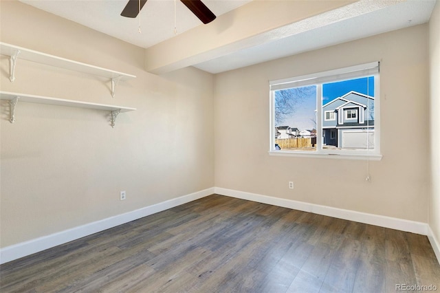 empty room featuring ceiling fan and dark hardwood / wood-style flooring