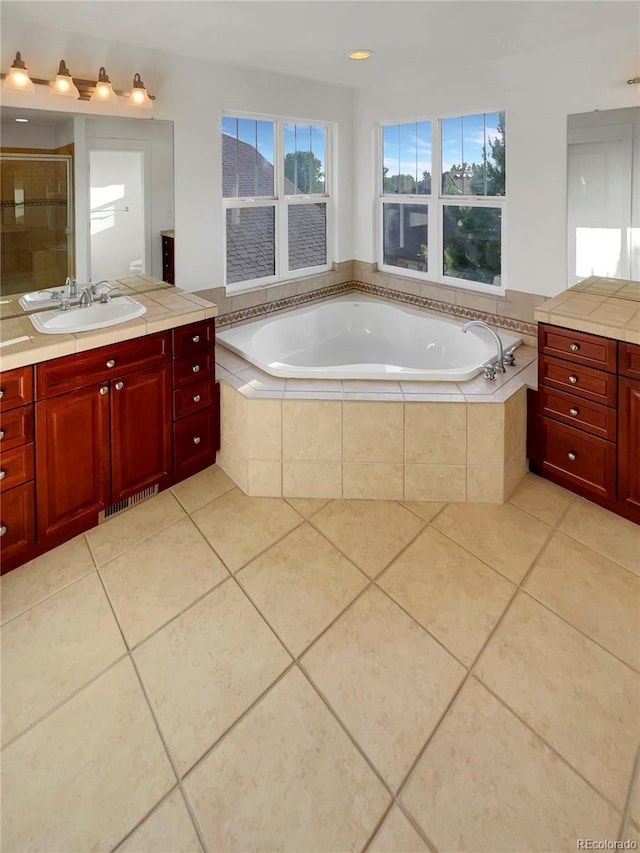 24955 E Roxbury Pl, Aurora, CO 80016 - bathroom featuring vanity, tile patterned flooring, a bath, and a stall shower