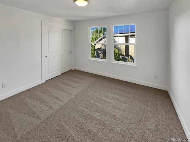 24955 E Roxbury Pl, Aurora, CO 80016 - unfurnished bedroom featuring carpet flooring and a closet