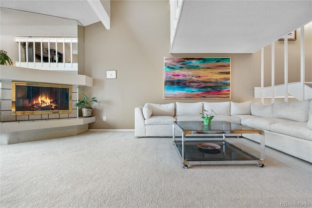 7160 W Stetson Pl Unit 27, Littleton, CO 80123 - living room with a glass covered fireplace, carpet flooring, and a textured ceiling