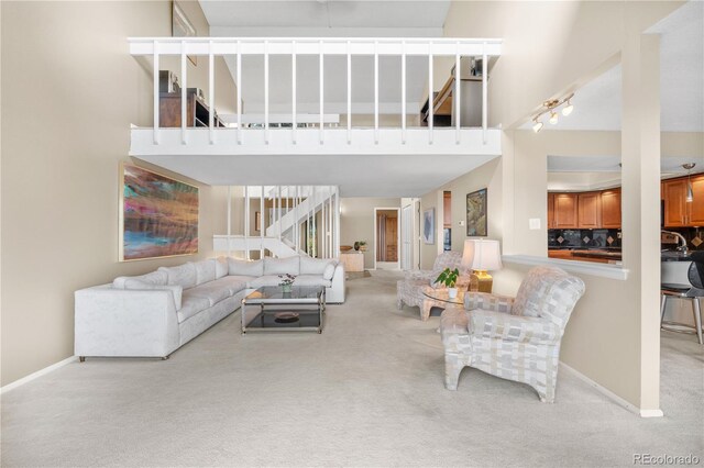7160 W Stetson Pl Unit 27, Littleton, CO 80123 - carpeted living area with a high ceiling, stairs, and baseboards