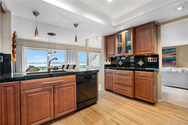 7160 W Stetson Pl Unit 27, Littleton, CO 80123 - kitchen with black dishwasher, tile counters, brown cabinets, and recessed lighting
