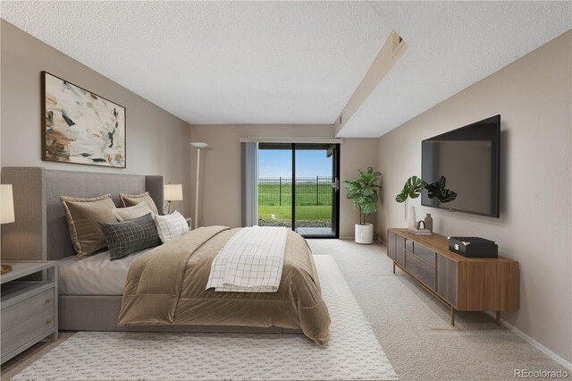 7160 W Stetson Pl Unit 27, Littleton, CO 80123 - bedroom featuring access to outside, a textured ceiling, and light carpet