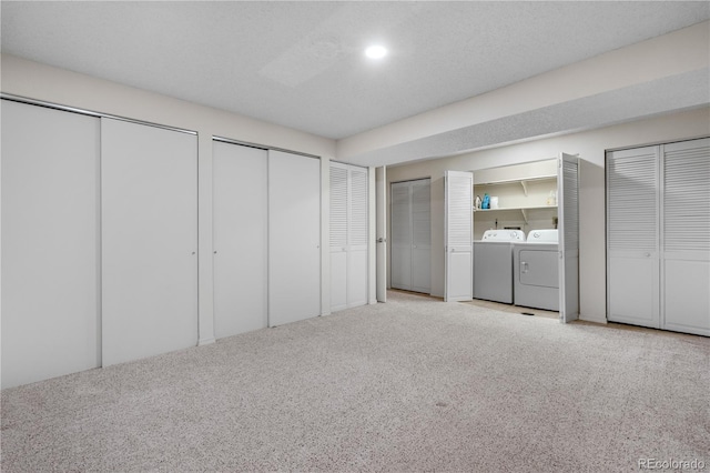 7160 W Stetson Pl Unit 27, Littleton, CO 80123 - unfurnished bedroom with washing machine and dryer, carpet flooring, and two closets