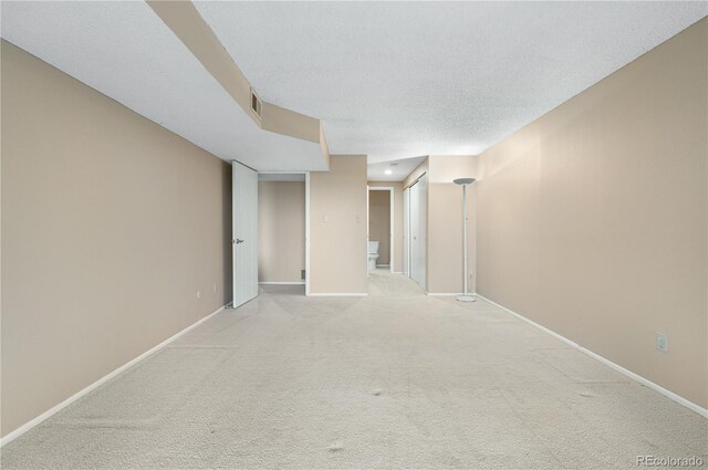 7160 W Stetson Pl Unit 27, Littleton, CO 80123 - unfurnished room with light carpet, baseboards, and a textured ceiling