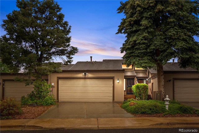 7160 W Stetson Pl Unit 27, Littleton, CO 80123 - view of front of house with a garage, stucco siding, and driveway