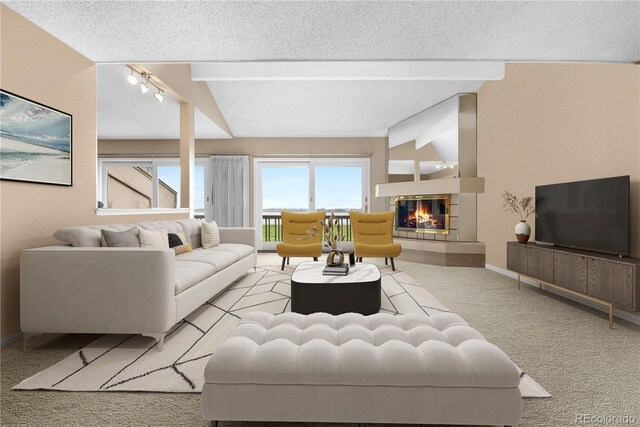 7160 W Stetson Pl Unit 27, Littleton, CO 80123 - living area with light colored carpet, baseboards, a tiled fireplace, beam ceiling, and a textured ceiling