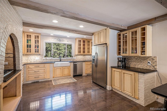 kitchen with tasteful backsplash, sink, dark hardwood / wood-style flooring, stainless steel appliances, and beam ceiling