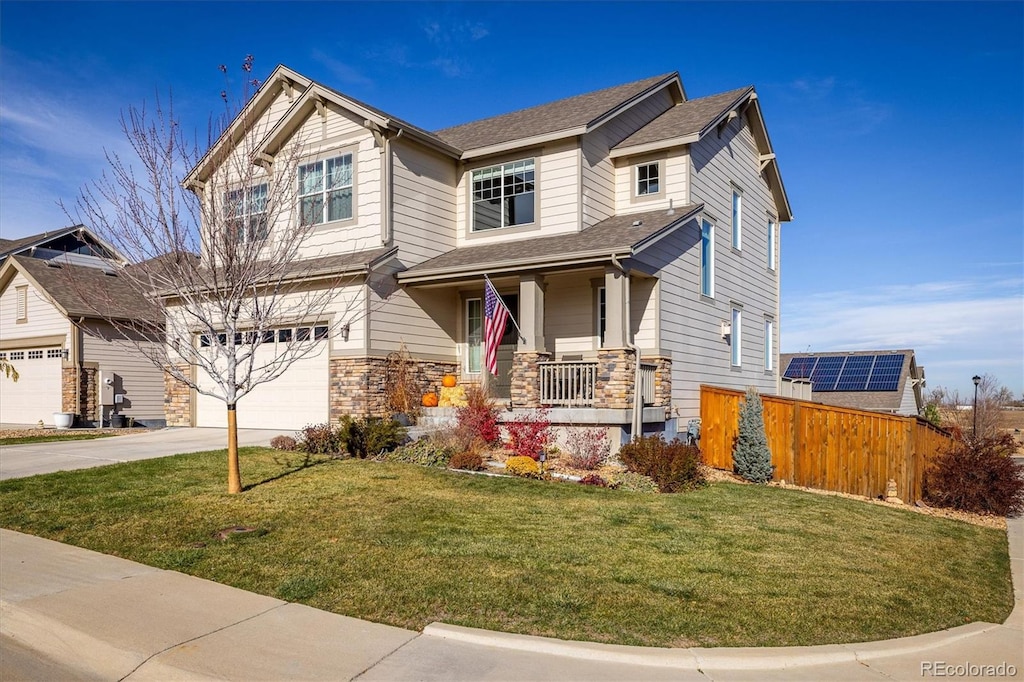 craftsman house featuring a porch, a garage, and a front yard