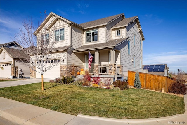 craftsman house featuring a porch, a garage, and a front yard