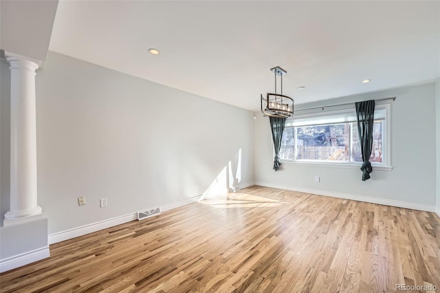 unfurnished dining area with light hardwood / wood-style flooring and an inviting chandelier