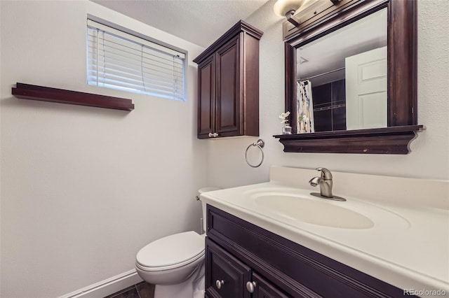 bathroom featuring toilet, a shower with curtain, and vanity