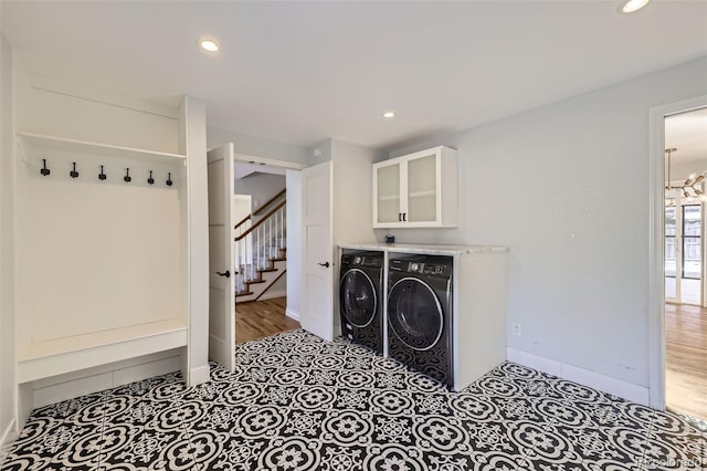 washroom with cabinets and washer and clothes dryer