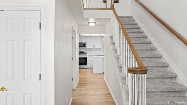 stairs featuring wood finished floors