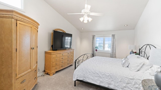 bedroom with a ceiling fan, lofted ceiling, and light carpet