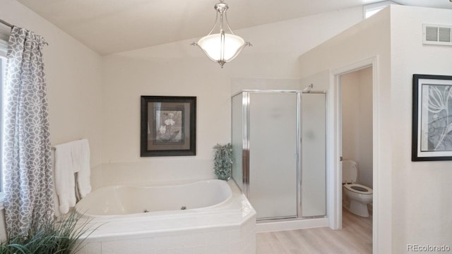 bathroom featuring a whirlpool tub, a stall shower, visible vents, and lofted ceiling