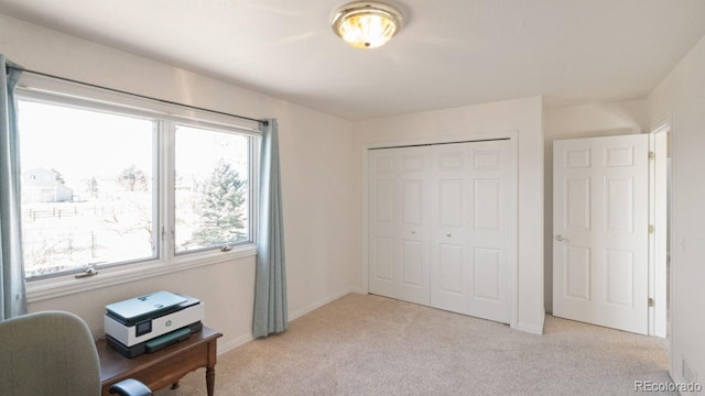 home office featuring light carpet and baseboards