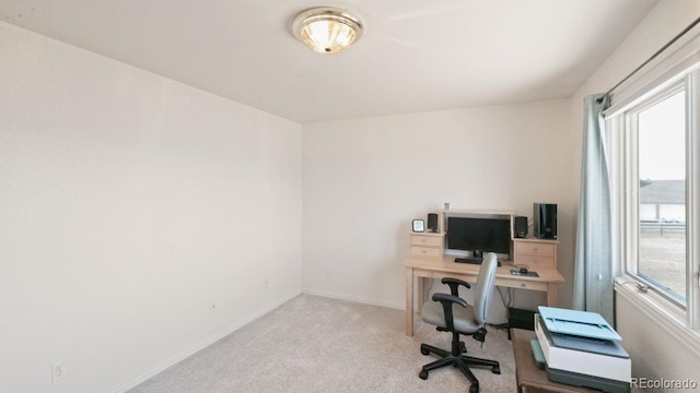 carpeted office space featuring baseboards