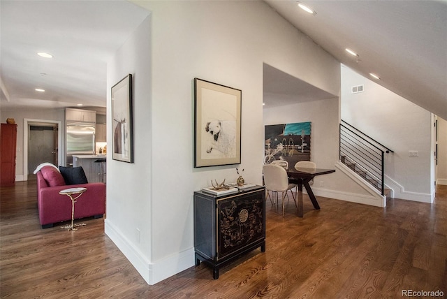 corridor featuring vaulted ceiling and dark wood-type flooring