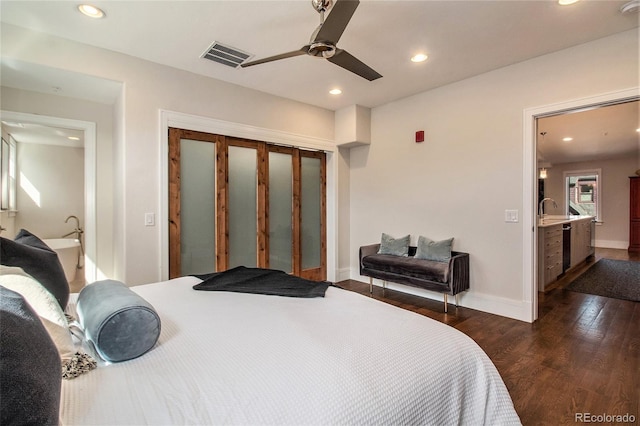 bedroom featuring a closet, ceiling fan, dark hardwood / wood-style flooring, and sink