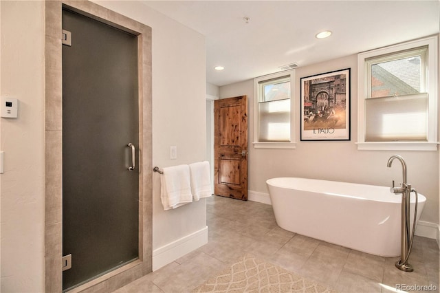 bathroom with tile patterned floors, shower with separate bathtub, and a wealth of natural light