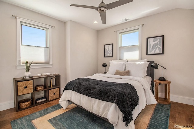 bedroom with dark hardwood / wood-style floors and ceiling fan