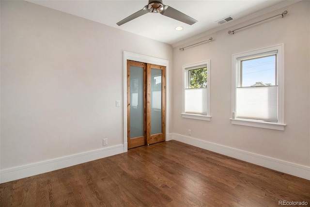 empty room featuring ceiling fan and dark wood-type flooring