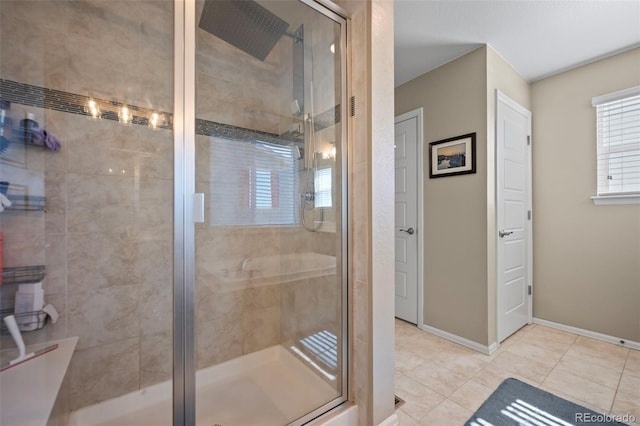 full bath featuring baseboards, a stall shower, and tile patterned floors