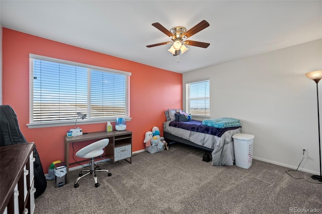 carpeted bedroom with ceiling fan and baseboards