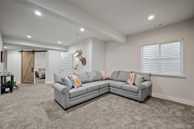 carpeted living area featuring a barn door, recessed lighting, visible vents, and baseboards