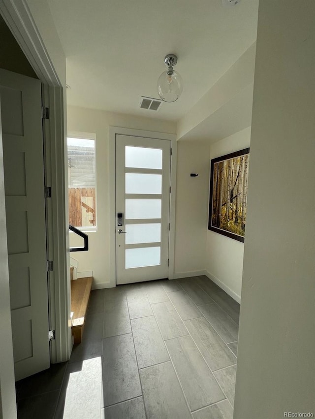 1284 Osceola St, Denver, CO 80204 - doorway to outside featuring tile patterned flooring