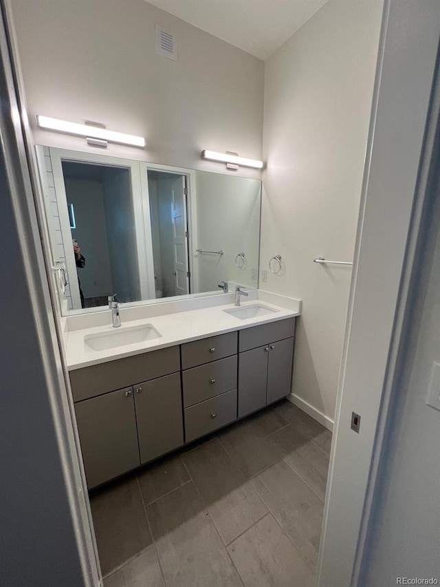 1284 Osceola St, Denver, CO 80204 - bathroom with double vanity and baseboards