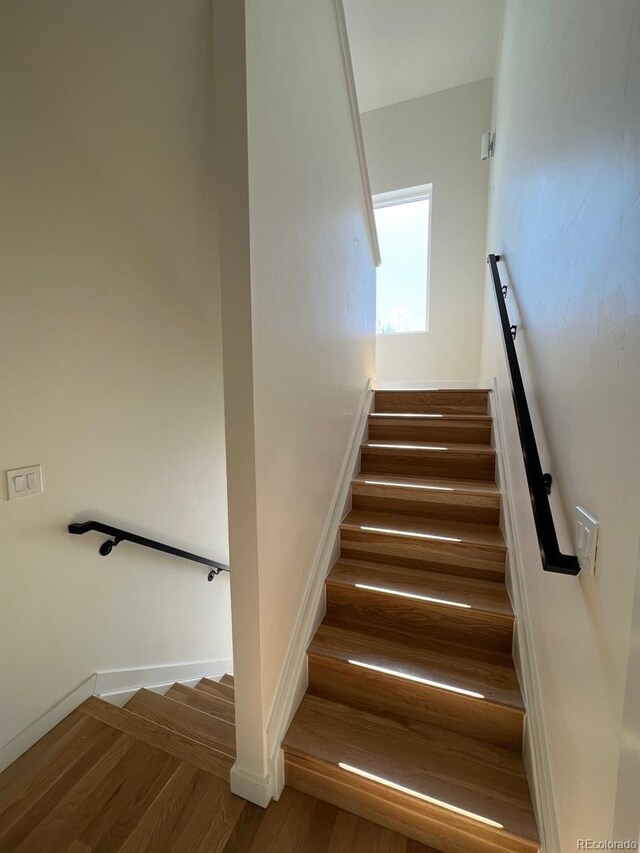 1284 Osceola St, Denver, CO 80204 - stairway featuring wood finished floors and baseboards