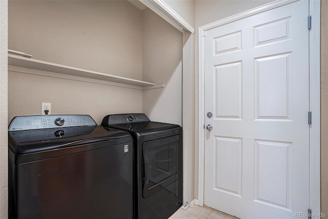 laundry area with light tile patterned floors, laundry area, and washer and dryer