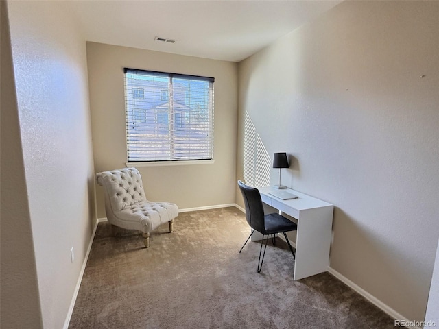 carpeted office space featuring baseboards and visible vents