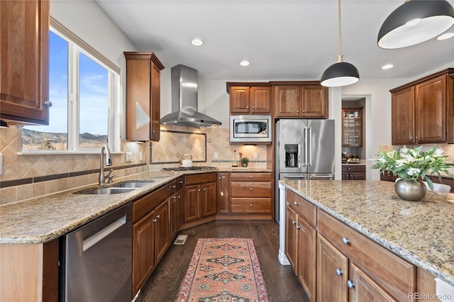 5322 Devils Head Cir, Golden, CO 80403 - kitchen featuring appliances with stainless steel finishes, wall chimney exhaust hood, light stone countertops, dark wood-type flooring, and decorative backsplash