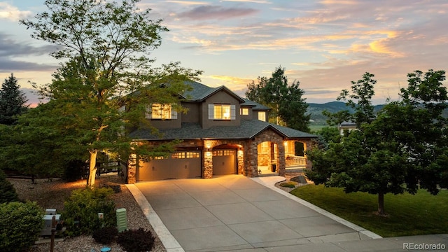 5322 Devils Head Cir, Golden, CO 80403 - view of front facade featuring stone siding, concrete driveway, and a garage