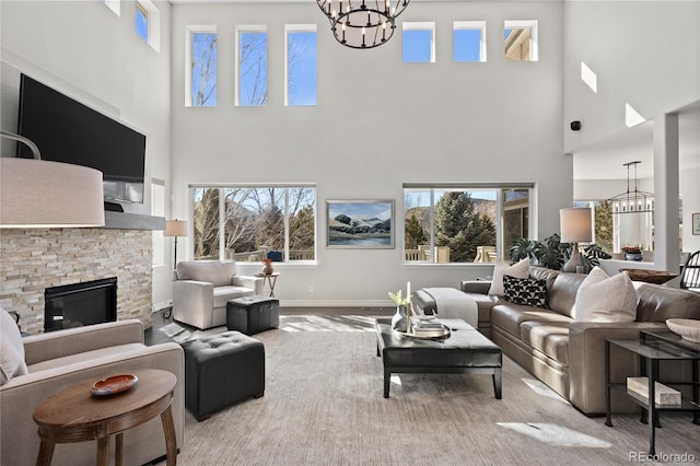 5322 Devils Head Cir, Golden, CO 80403 - living area featuring a chandelier, a towering ceiling, healthy amount of natural light, and a stone fireplace
