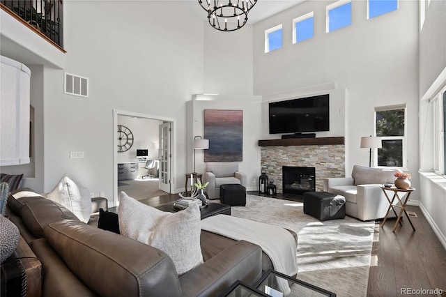 5322 Devils Head Cir, Golden, CO 80403 - living room with wood finished floors, a high ceiling, a chandelier, baseboards, and a fireplace