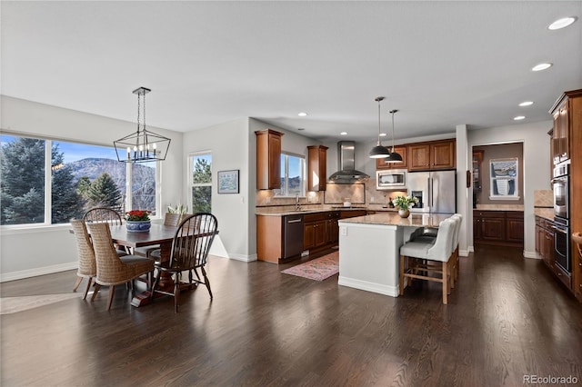 5322 Devils Head Cir, Golden, CO 80403 - kitchen featuring wall chimney range hood, stainless steel appliances, plenty of natural light, a center island, and recessed lighting