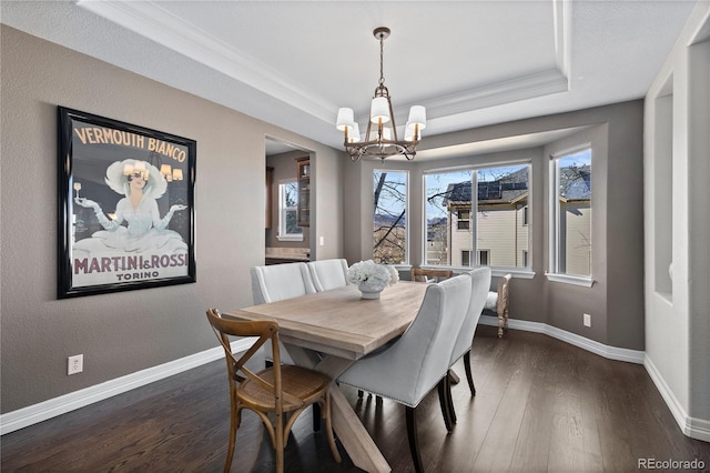 5322 Devils Head Cir, Golden, CO 80403 - dining space featuring a chandelier, a tray ceiling, dark wood-style floors, crown molding, and baseboards