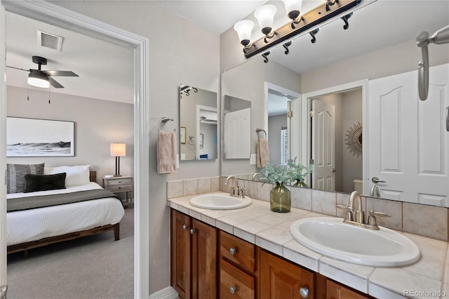 5322 Devils Head Cir, Golden, CO 80403 - ensuite bathroom with double vanity, ceiling fan, and toilet