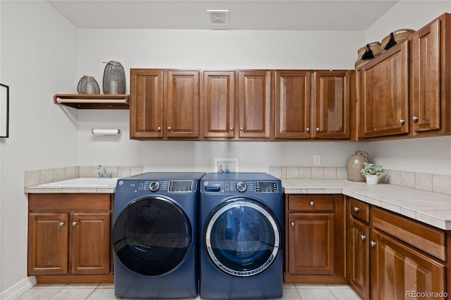 5322 Devils Head Cir, Golden, CO 80403 - laundry area featuring cabinet space, washer and clothes dryer, and light tile patterned floors