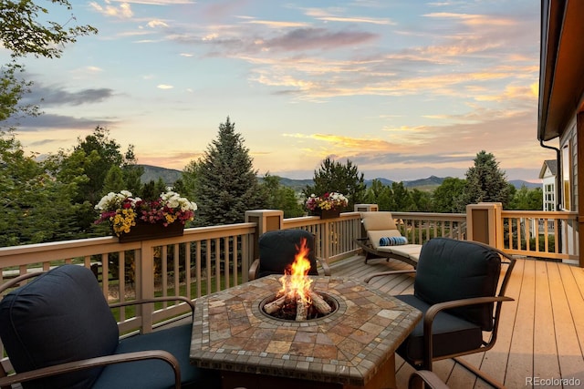 5322 Devils Head Cir, Golden, CO 80403 - deck at dusk featuring a fire pit and a mountain view