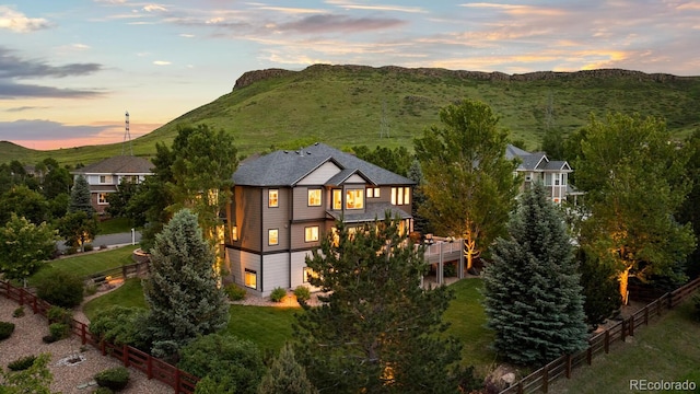 5322 Devils Head Cir, Golden, CO 80403 - back of house at dusk featuring a garage and a wooden deck
