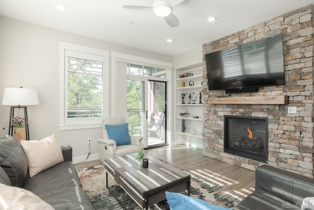 400 Baker Dr Unit Te103, Winter Park, CO 80482 - living area with wood finished floors, ceiling fan, a stone fireplace, built in shelves, and recessed lighting