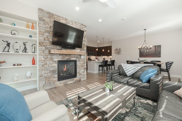 400 Baker Dr Unit Te103, Winter Park, CO 80482 - living room with wood finished floors, a fireplace, a chandelier, and built in features