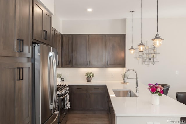 400 Baker Dr Unit Te103, Winter Park, CO 80482 - kitchen featuring stainless steel appliances, a peninsula, decorative backsplash, and light countertops