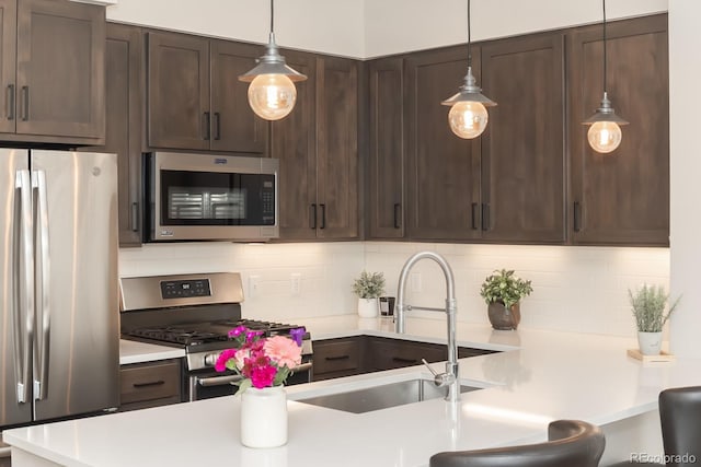 400 Baker Dr Unit Te103, Winter Park, CO 80482 - kitchen featuring stainless steel appliances, dark brown cabinets, light countertops, and backsplash