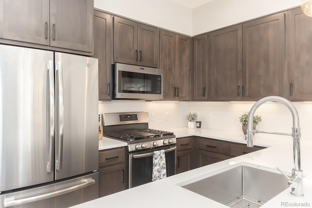 400 Baker Dr Unit Te103, Winter Park, CO 80482 - kitchen featuring stainless steel appliances, dark brown cabinets, light countertops, and backsplash